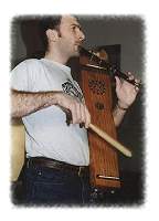 A Tabor having 3-6 strings stretched over a resonating box, something like a guitar or ukelele without a fingerboard